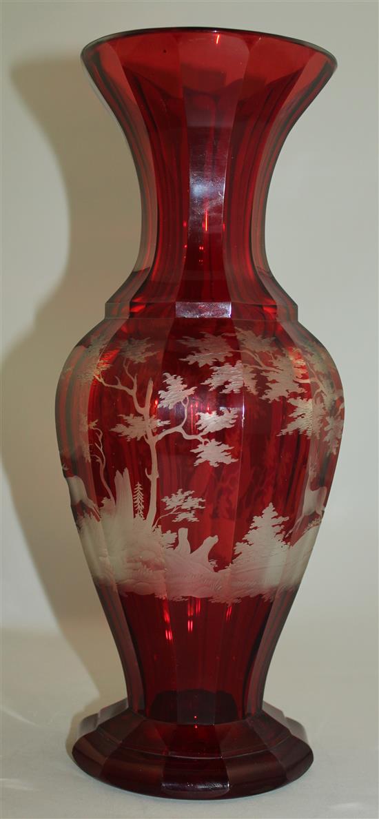 A Bohemian ruby glass multi-facetted baluster vase, late 19th century, 31.5cm